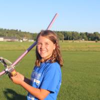 Student poses with her plane she made from STEPS 2026